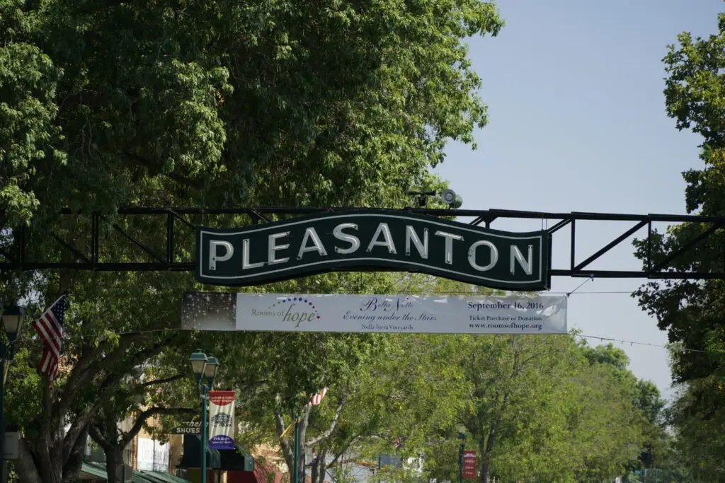 A sign hanging from the side of a metal structure.