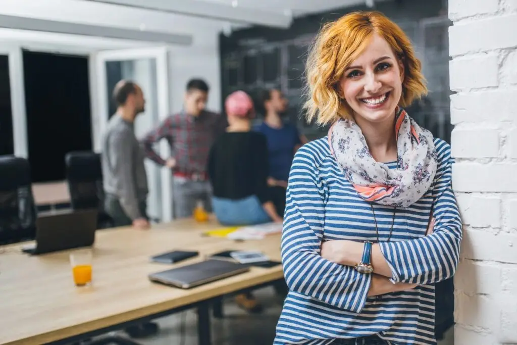 A woman standing in front of other people.